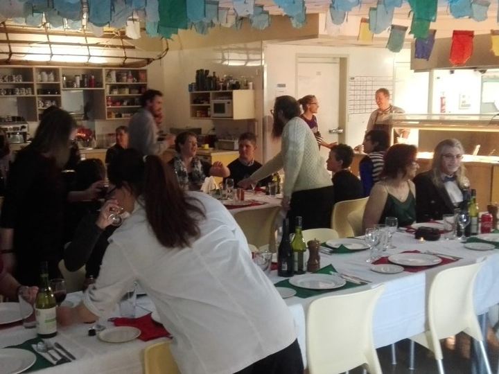 Researchers gathered at a long dining table for the Midwinter dinner at Scott Base, Antarctica