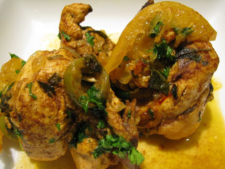 Chicken tagine with preserved lemon slices, olives and herbs in a golden sauce