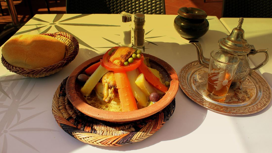 Chicken and vegetable tagine served with bread and mint tea in Marrakech